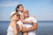 Little girl with grandparents spending time near sea