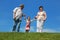 Little girl and grandparents standing on lawn