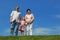 Little girl and grandparents standing on lawn