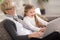 Little girl and granny together using laptop at home