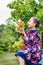 Little girl with grapes in the garden.