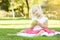 Little Girl In Grass Eating Healthy Apple