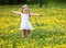 Little girl on grass in flower.