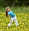 Little girl on grass in flower at nature.