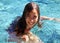 Little girl green eyes children playing at pool at tropical resort in Los Cabos Mexico