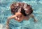 Little girl green eyes children playing at pool at tropical resort in Los Cabos Mexico