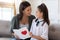 Little girl greeting mum with handmade postcard