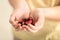 Little girl with handful of small colorful hearts, closeup