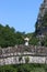 Little girl with hands up standing on kokkori stone bridge