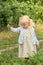 The little girl harvests carrots and eats carrots