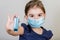 Little girl has fabric mask protect herself from Coronavirus COVID-19