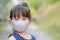 Little girl has fabric mask protect herself from Coronavirus COVID-19,hand stop sign when child leave the house,,child