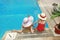 Little girl in a hat with mother in swimming pool