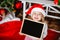 Little girl in the hat of Santa Claus with Boards