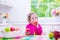 Little girl having fruit for breakfast