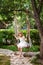 Little girl having fun on a swing outdoor. Child playing, garden playground.