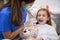 Little girl having her teeth checked