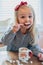 Little girl having a mug of hot cocoa with marshmallows