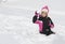 Little girl having a snowball fight