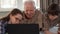 Little girl help her grandpa to type on laptop