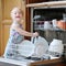 Little girl helping with dish washing machine