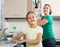 Little girl helping mother at kitchen