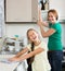 Little girl helping mother at kitchen