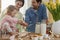 Little girl helping parents in the kitchen