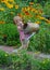 Little girl helps water the flowers