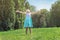 Little girl with her arms open, in the park; life and natur