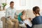 Little girl and her father on appointment with child psychotherapist