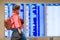 Little girl with her father background flight information at airport