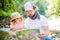 Little girl and her father exploring map in the forest or park