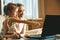 A little girl and her grandfather using a laptop together. Two generations learning how to use technologies