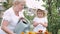 Little girl and her grandmother watering flowers in garden