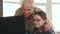 Little girl and her grandpa have video chat on laptop