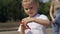 A little girl and her mother launch a kite, a girl winds a thread on a spool.