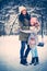 Little girl with her mother outdoor in a snow