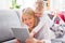 Little girl with her mother using tablet computer