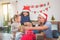 Little girl and her parents open christmas gift boxes