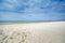 A little girl and her parents walk on the beach in swimsuits on the Baltic Sea in Lithuania