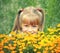 Little girl hiding behind flowers