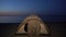 Little girl hiding in tent at night seaside, homeless children camp, poverty