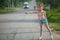 Little girl hitchhiking along a road. Travel.