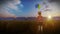 Little Girl holding Balloons on wheat field with Solar Panel Farm at sunset, 4K