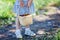 Little girl holding basket full of ripe strawberries at pick your own farm.