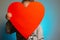 Little girl holding big red heart blank inside