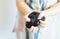 A little girl is holding a black slime in her hands. Close-up of sticky, shiny mucus in children\'s palms.