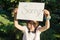 Little girl holding blank paper with message sorry