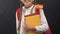 Little girl holding books with Spanish flag and smiling at camera, language